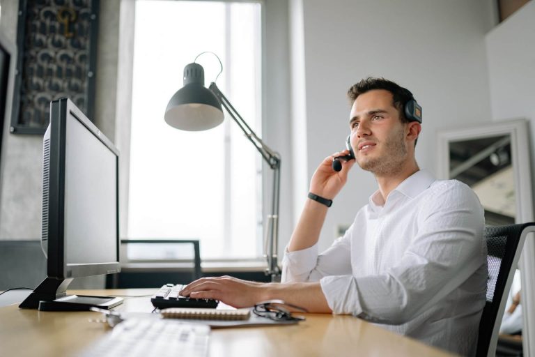 a guy in the office calling using a cloud phone system