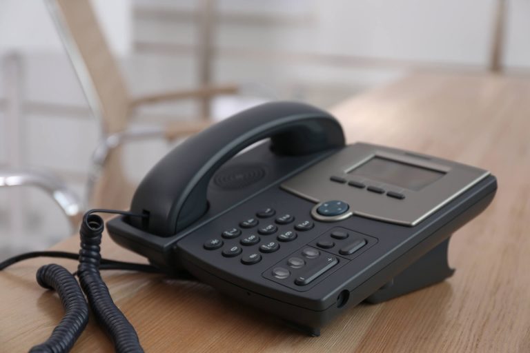 desktop telephone on wooden table