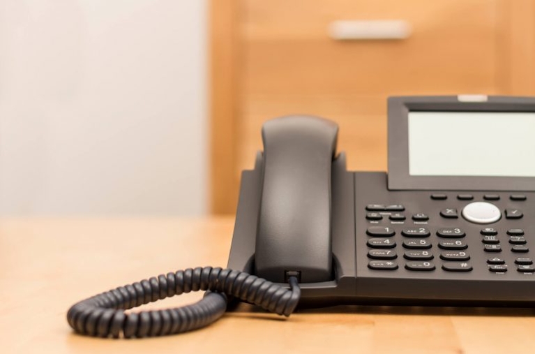 a voip phone in a desk